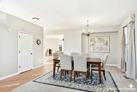 a dining room with furniture a rug and wooden floor