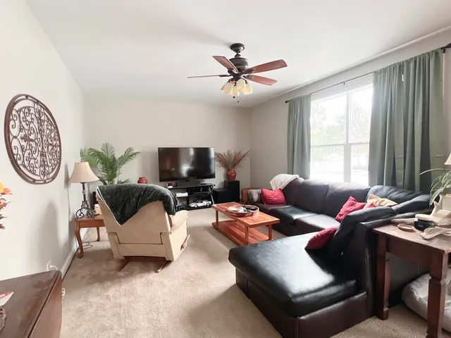 a dining room with furniture a rug and wooden floor