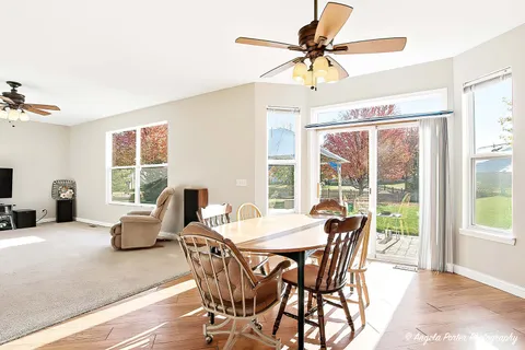 a living room with furniture a flat screen tv and a chandelier