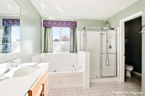 a bathroom with a sink a mirror and a shower