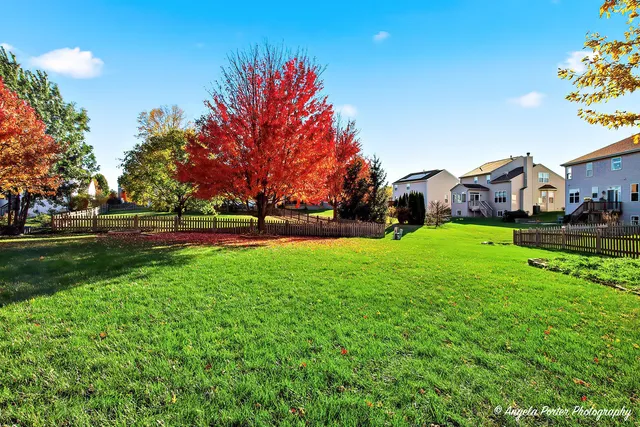 a view of an house with backyard space and garden