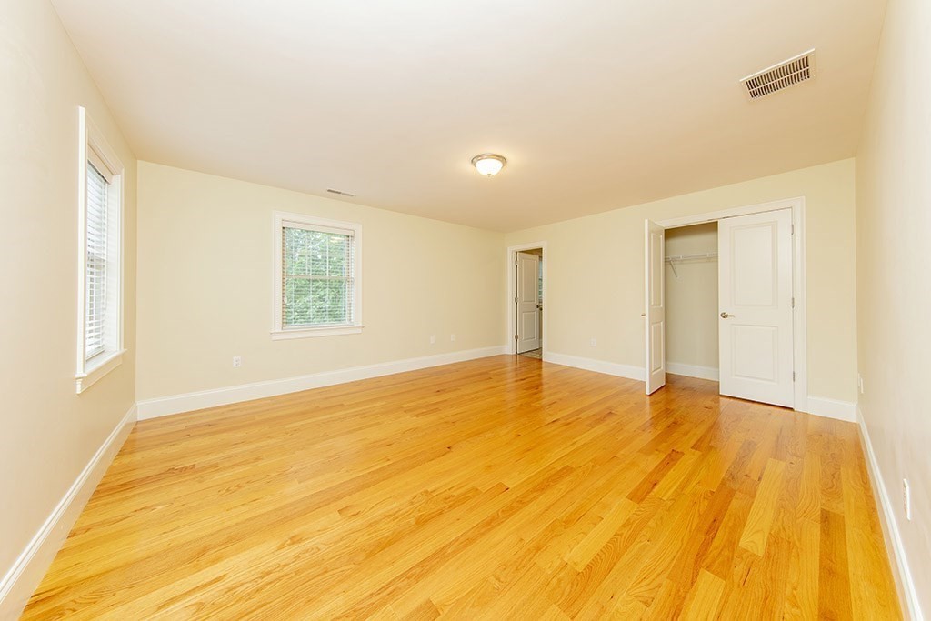 33 Liberty Avenue Lexington, MA 02420 - Photo 18 of 30 a view of an empty room with wooden floor and a window