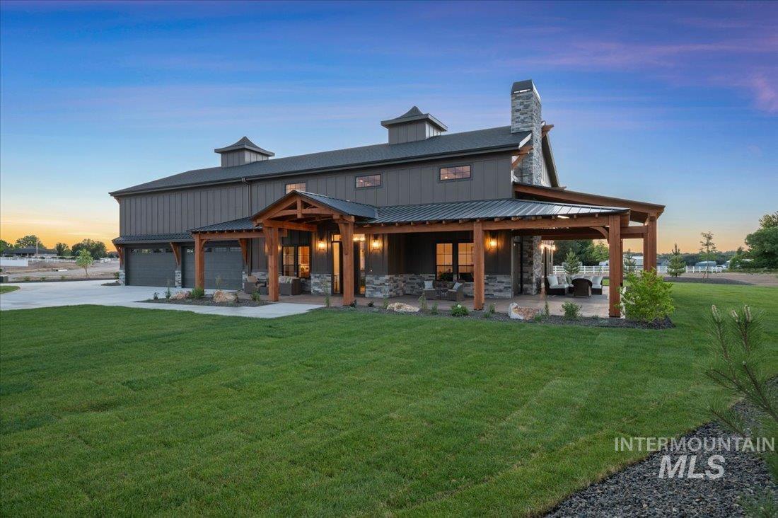 8860 Kemp Middleton, ID 83644 - Photo 2 of 50 Rear view of house featuring a yard, driveway, a chimney, and a patio area