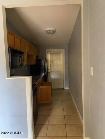 a kitchen with a refrigerator and microwave