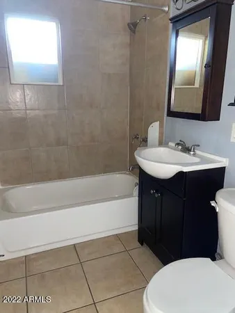 a bathroom with a sink a toilet and bathtub