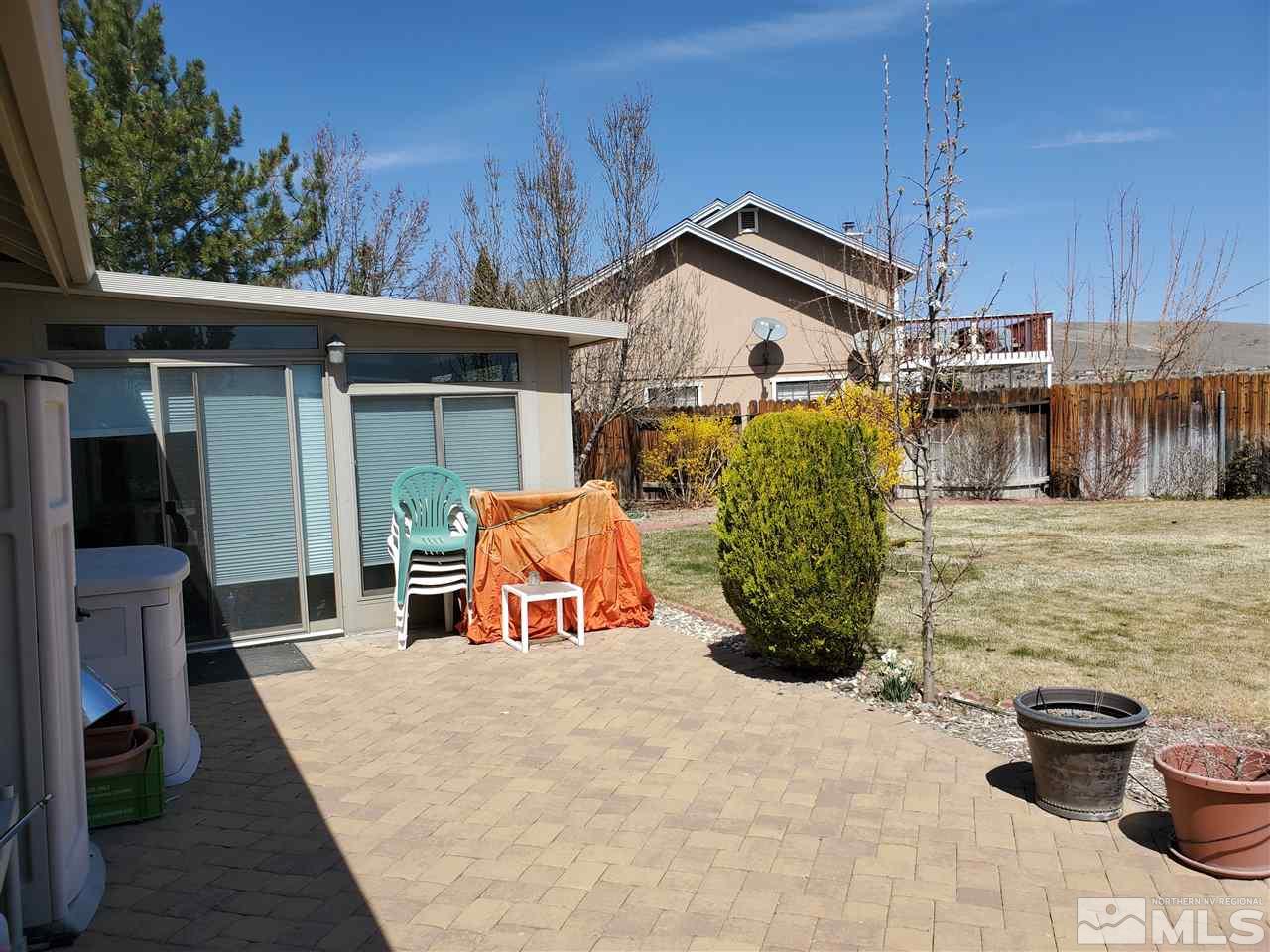 5299 Simons Drive Reno, NV 89523 - Photo 21 of 29 a view of a patio with table and chairs potted plants