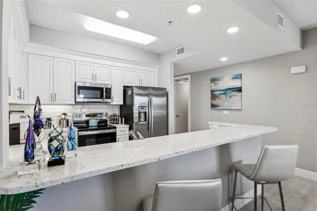 a bedroom with a large bed and a dresser