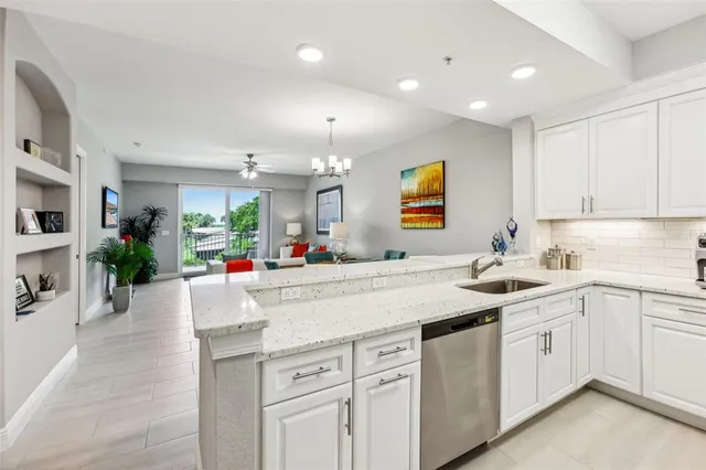 a bedroom with a bed and a lamp on dresser