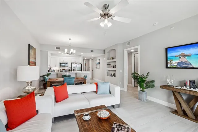 a living room with furniture and a potted plant