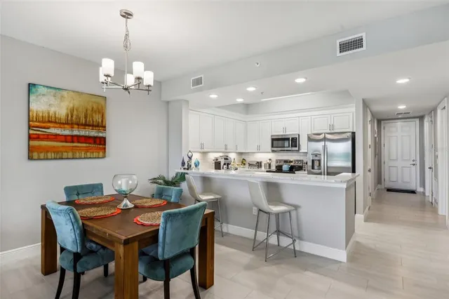a dining room with furniture a rug and a chandelier