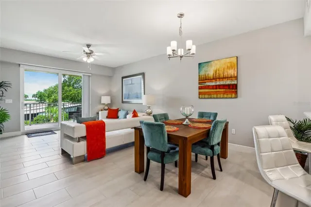 a dining room with furniture a rug and a chandelier
