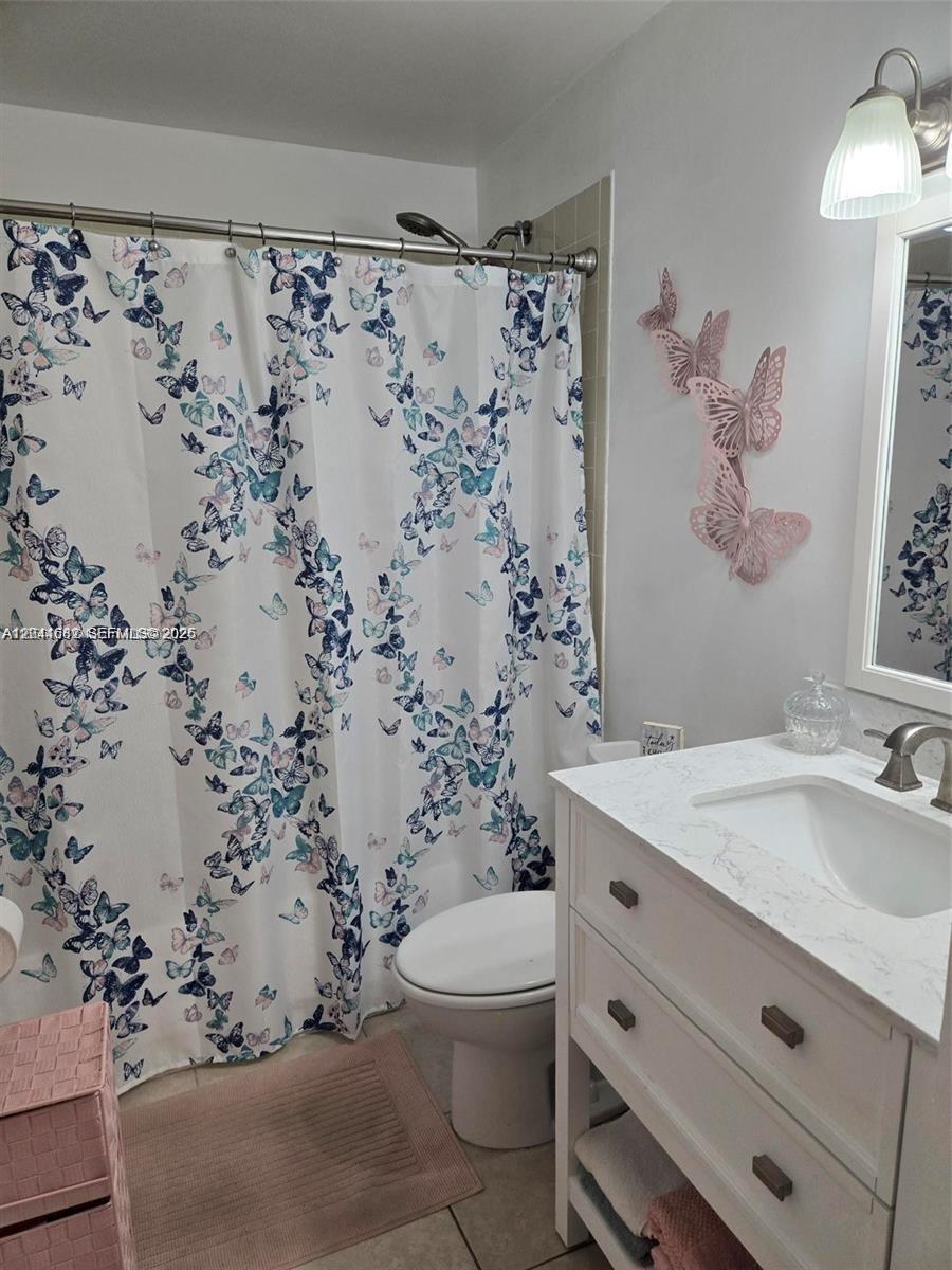 2174 West 60th Street, Unit 17205 Hialeah, FL 33016 - Photo 9 of 11 a bathroom with a sink toilet and shower