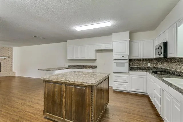 a kitchen with a stove top oven sink and cabinets