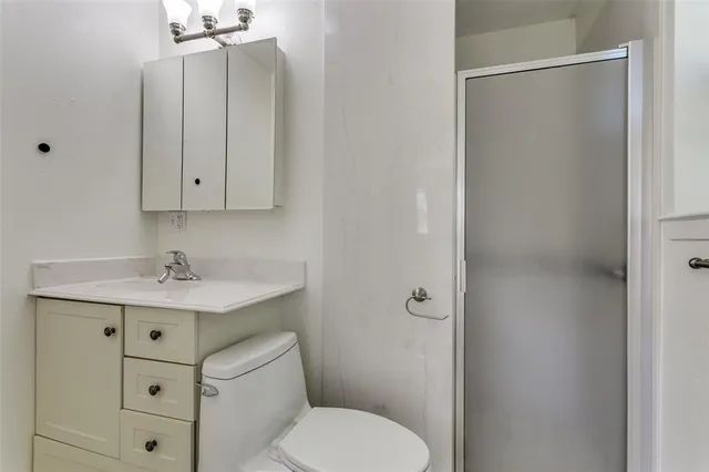 a bathroom with a sink a toilet and vanity
