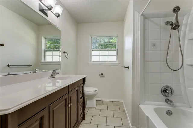 a bathroom with a double vanity sink toilet and shower