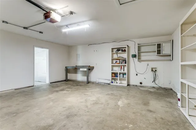 an empty room with furniture and a ceiling fan