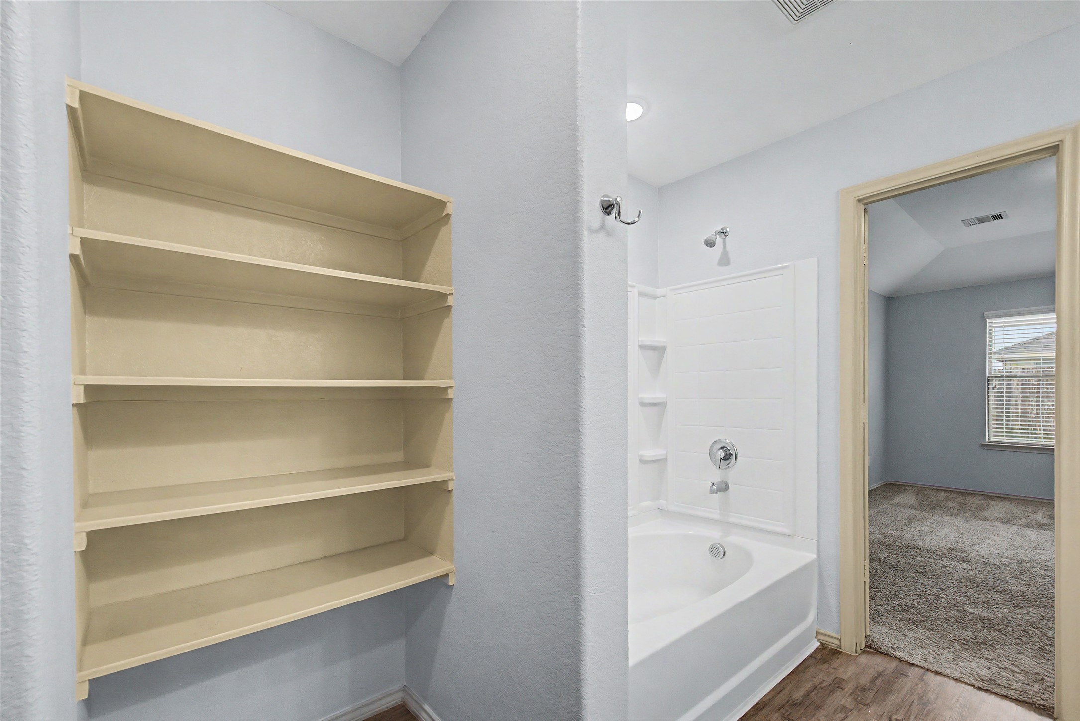 16430 Rodeo River Road Houston, TX 77049 - Photo 30 of 34 a bathroom with a bathtub and a shower