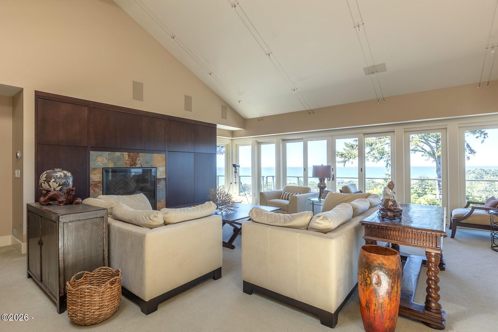 142 East Bay Point Road Gleneden Beach, OR 97388 - Photo 5 of 49 a living room with furniture and a floor to ceiling window