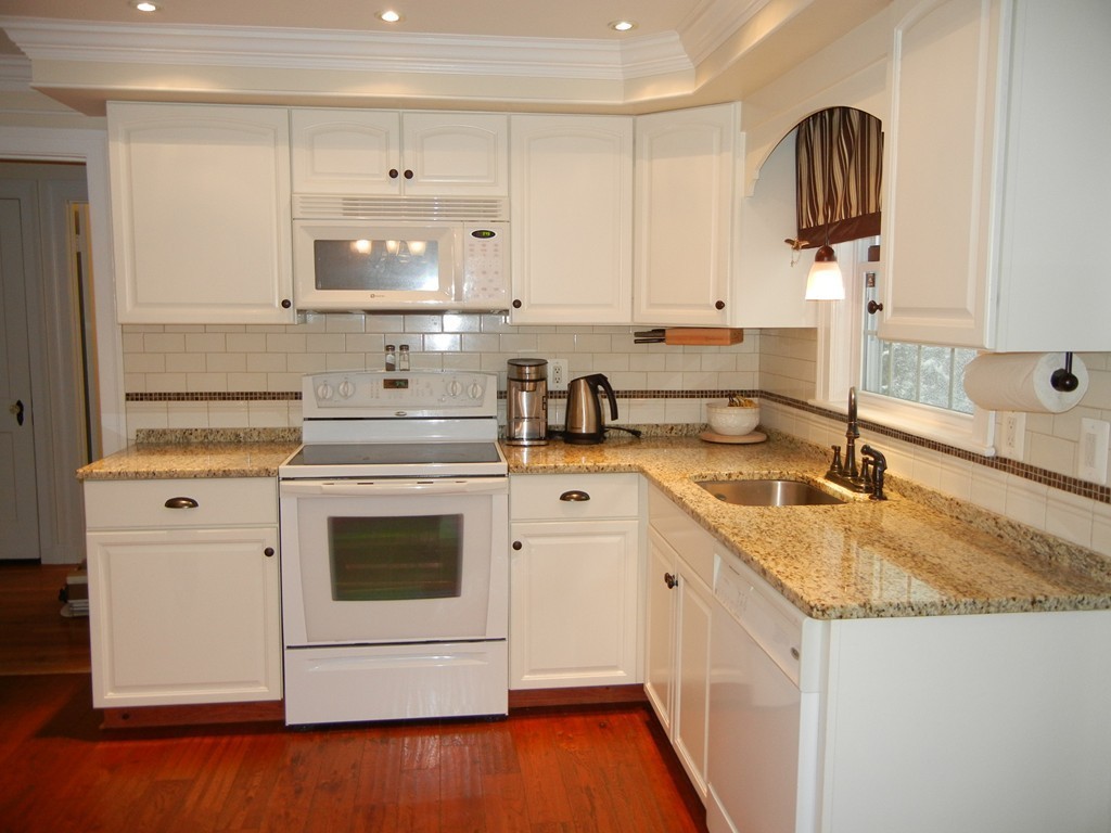 12 Calvert Road Walpole, MA 02032 - Photo 11 of 30 a kitchen with granite countertop white cabinets and white appliances