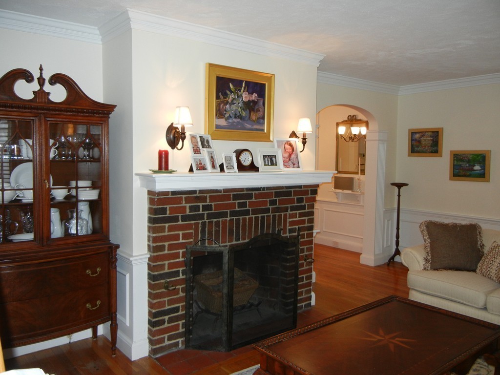 12 Calvert Road Walpole, MA 02032 - Photo 4 of 30 a living room with furniture a flat screen tv and a fireplace