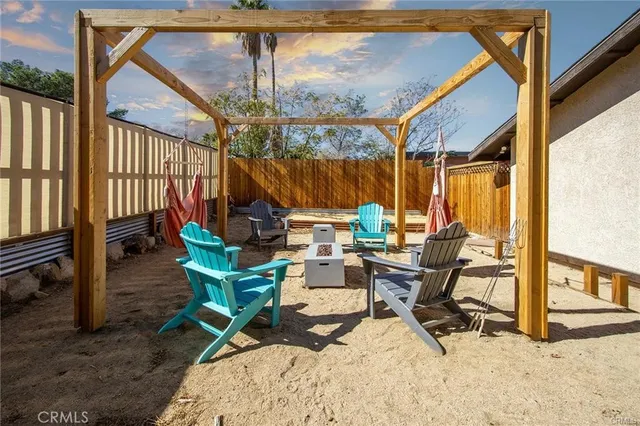 a view of a patio with a table chairs and a floor to ceiling window