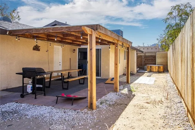 a backyard of a house with outdoor seating