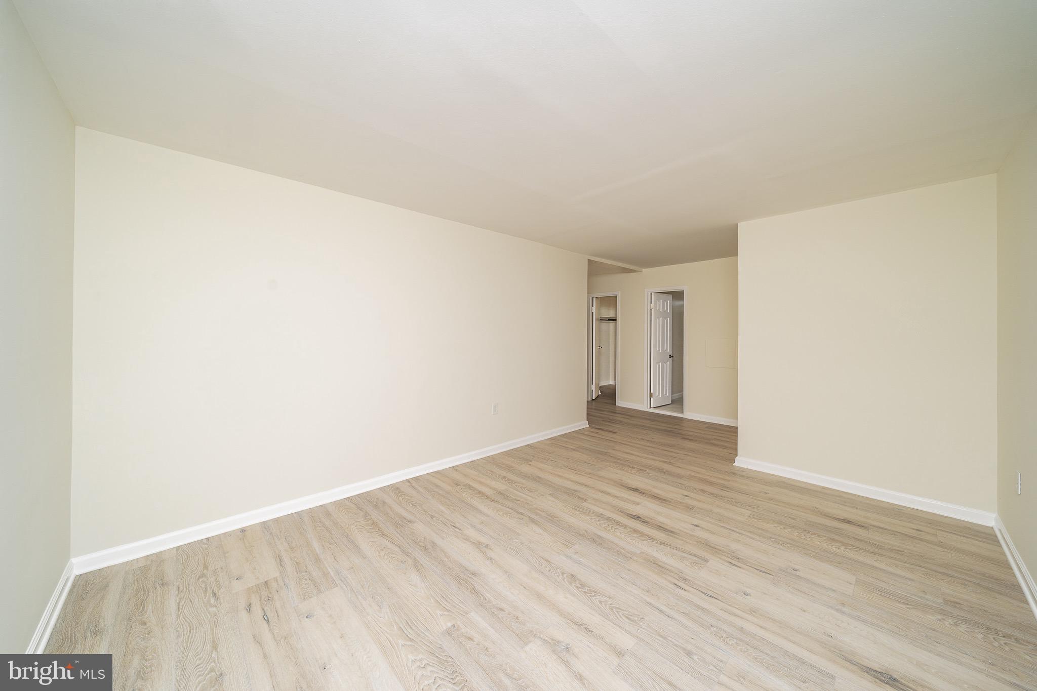 9910 Walker House Road, Unit 99104 Gaithersburg, MD 20886 - Photo 19 of 32 a view of an empty room and wooden floor