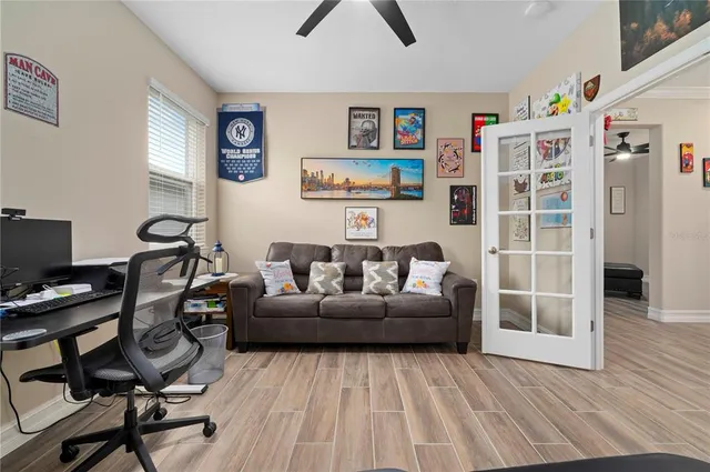 a bedroom with a bed and a flat tv screen on dresser