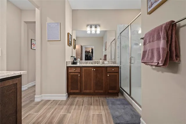 a bedroom with a bed and a dresser next to a window