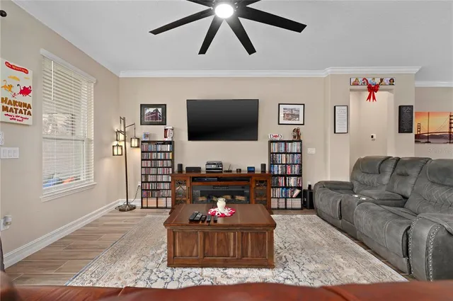 a living room with furniture and a ceiling fan