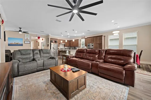 a kitchen with stainless steel appliances kitchen island granite countertop a refrigerator and a stove top oven