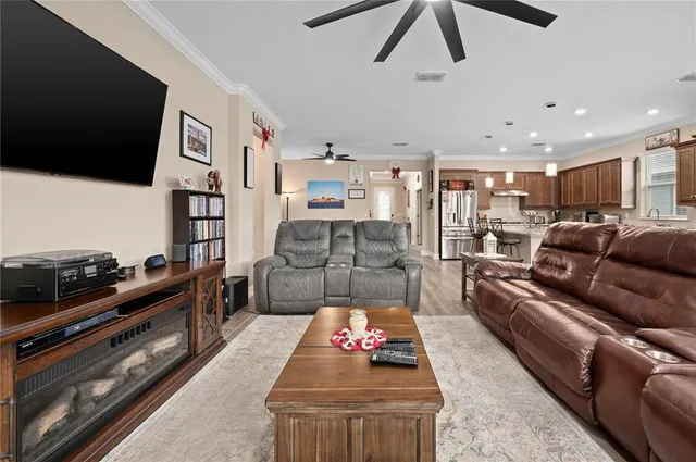 a kitchen with stainless steel appliances kitchen island granite countertop a stove a sink a refrigerator and cabinets