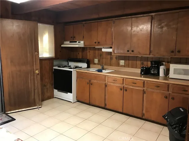 a kitchen with a sink cabinets and appliances