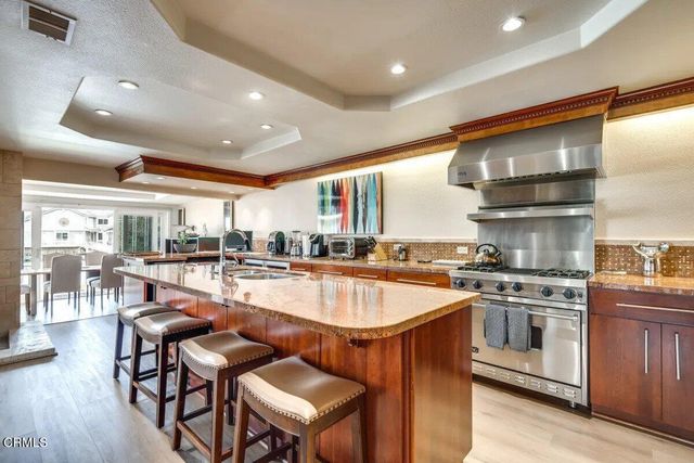 a kitchen with stainless steel appliances granite countertop a stove and a refrigerator