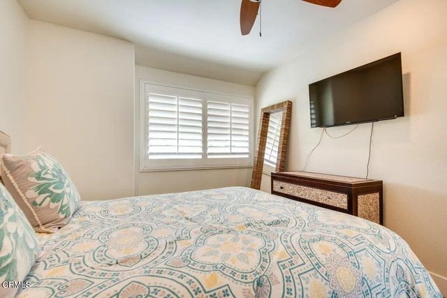 a bedroom with a bed and flat screen tv