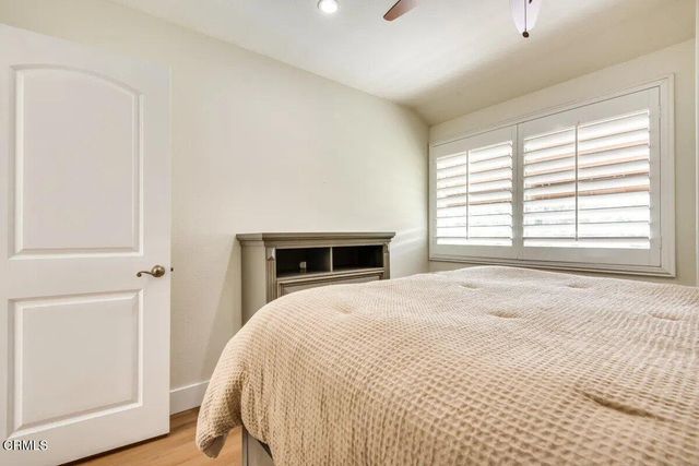 a spacious bedroom with a bed and a window