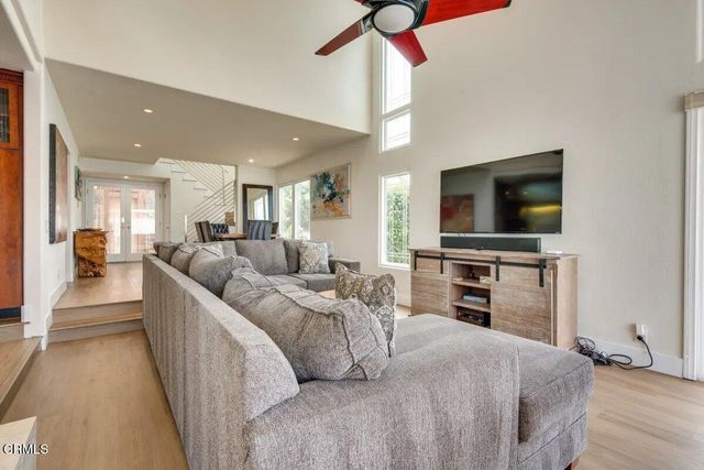 a large bedroom with a bed and a flat screen tv