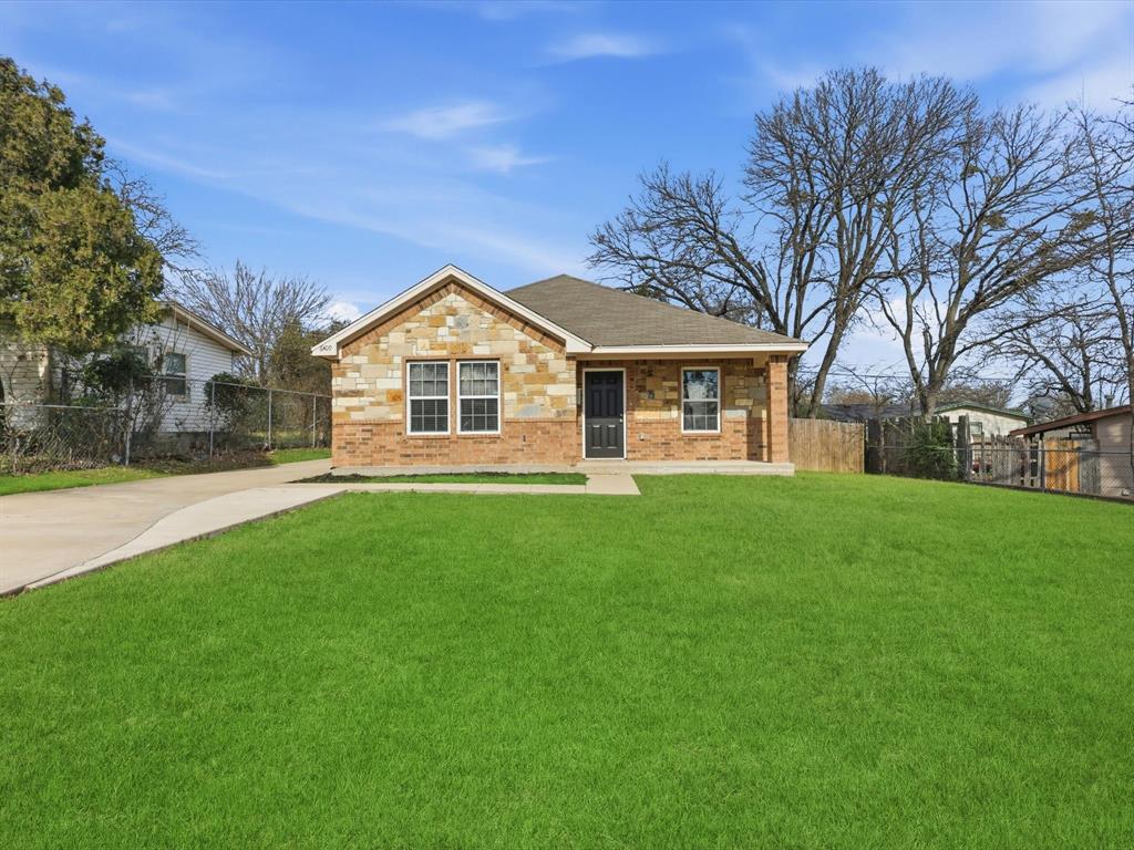 6409 Ramey Avenue Fort Worth, TX 76112 - Photo 1 of 25 a front view of a house with a garden and trees