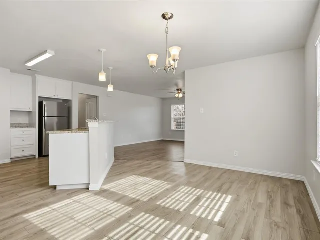 a view of a kitchen with a sink and refrigerator