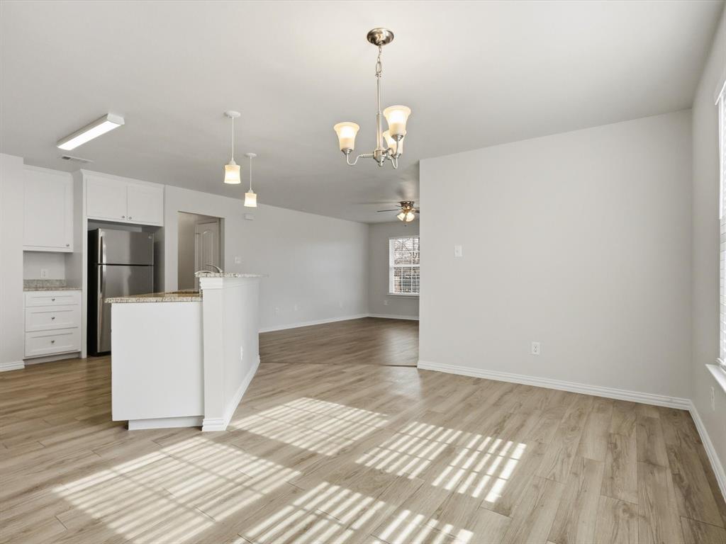 6409 Ramey Avenue Fort Worth, TX 76112 - Photo 11 of 25 a view of a kitchen with a sink and refrigerator