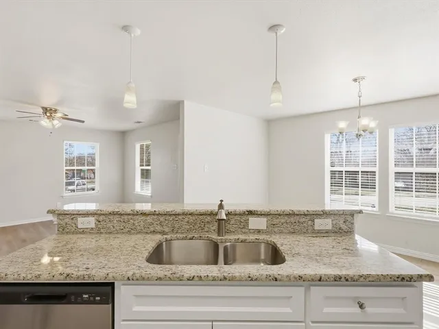 a kitchen with granite countertop a sink and window