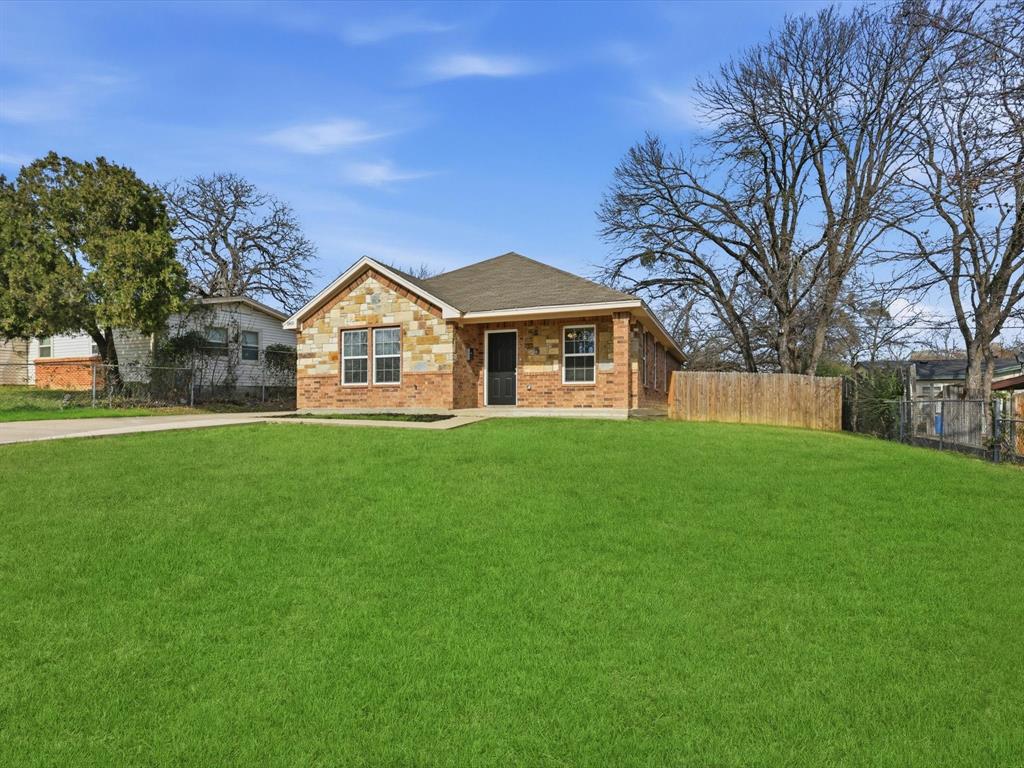 6409 Ramey Avenue Fort Worth, TX 76112 - Photo 2 of 25 a front view of a house with a garden