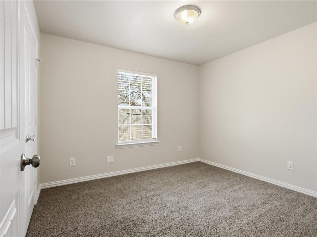 6409 Ramey Avenue Fort Worth, TX 76112 - Photo 21 of 25 an empty room with a window