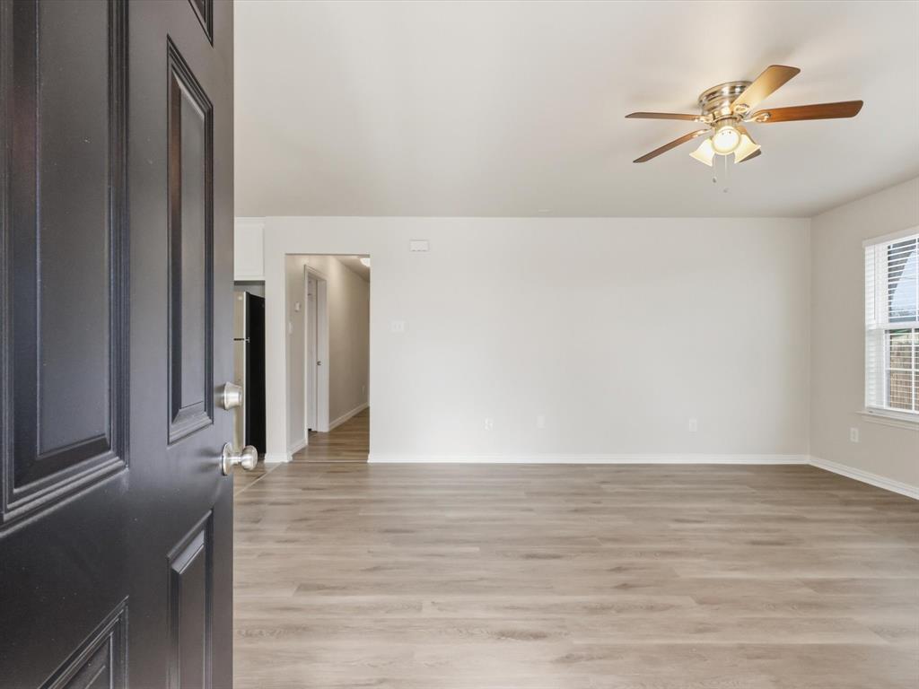 6409 Ramey Avenue Fort Worth, TX 76112 - Photo 5 of 25 a view of an empty room with wooden floor and a window