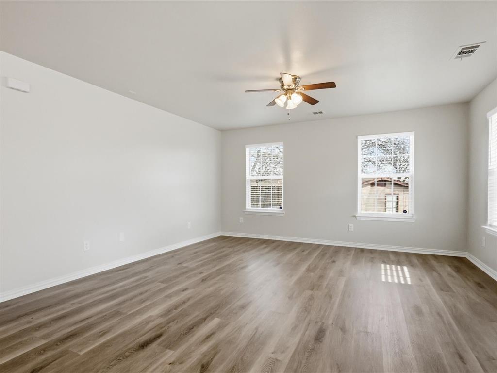 6409 Ramey Avenue Fort Worth, TX 76112 - Photo 6 of 25 wooden floor in an empty room with a window