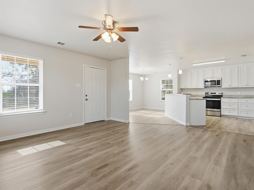 6409 Ramey Avenue Fort Worth, TX 76112 - Photo 8 of 25 a view of kitchen with granite countertop cabinets and refrigerator