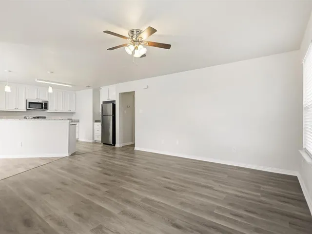 a view of a kitchen with a dishwasher cabinets and wooden floor