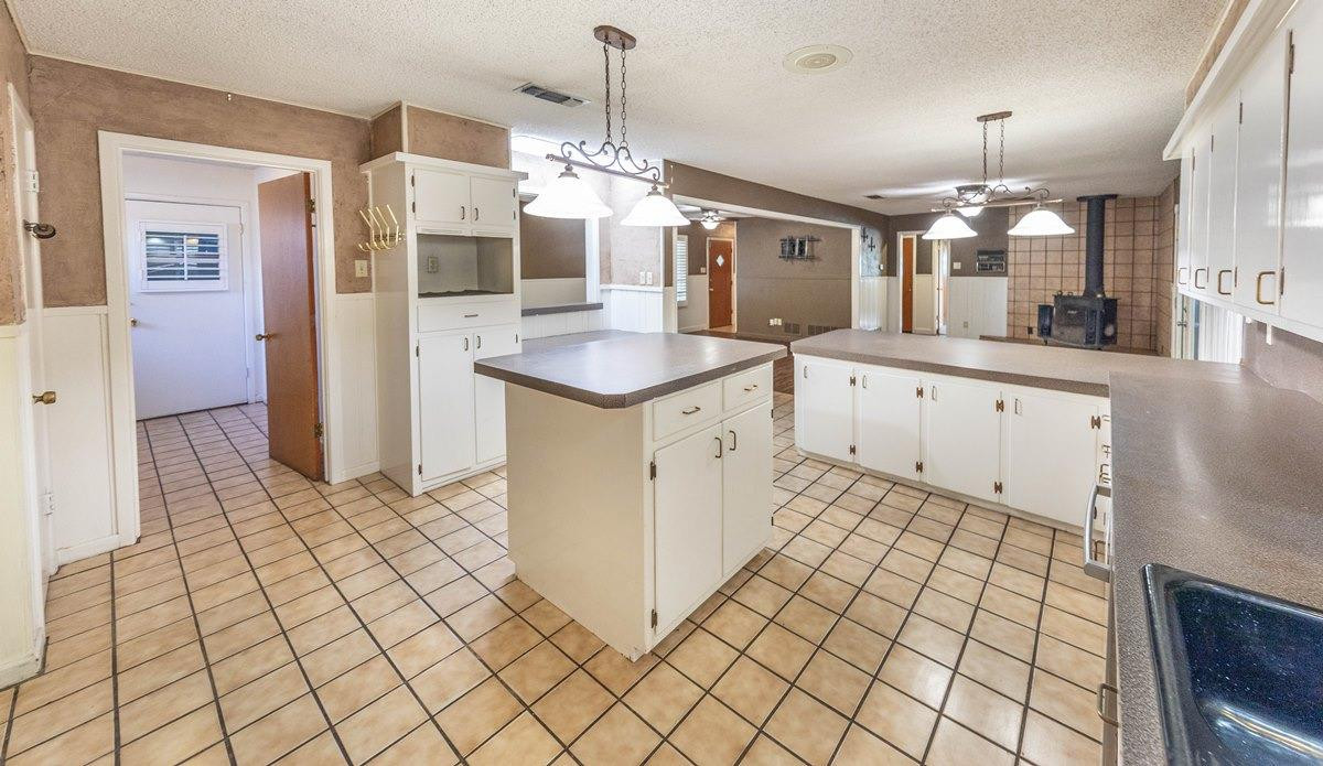 5415 8th Street Lubbock, TX 79416 - Photo 13 of 27 a kitchen with stainless steel appliances granite countertop a sink and cabinets