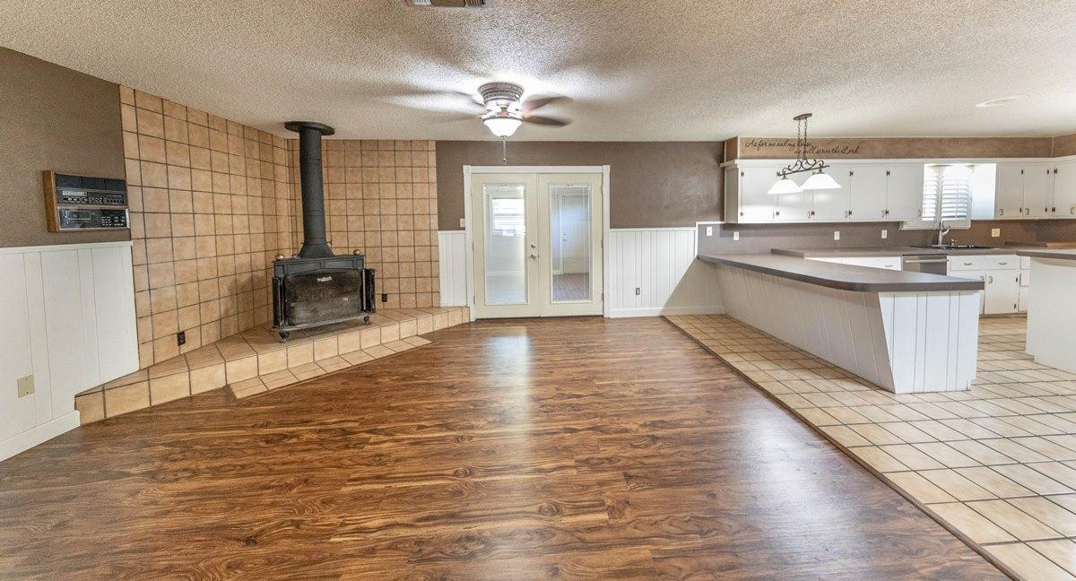 5415 8th Street Lubbock, TX 79416 - Photo 16 of 27 a large kitchen with cabinets and wooden floor