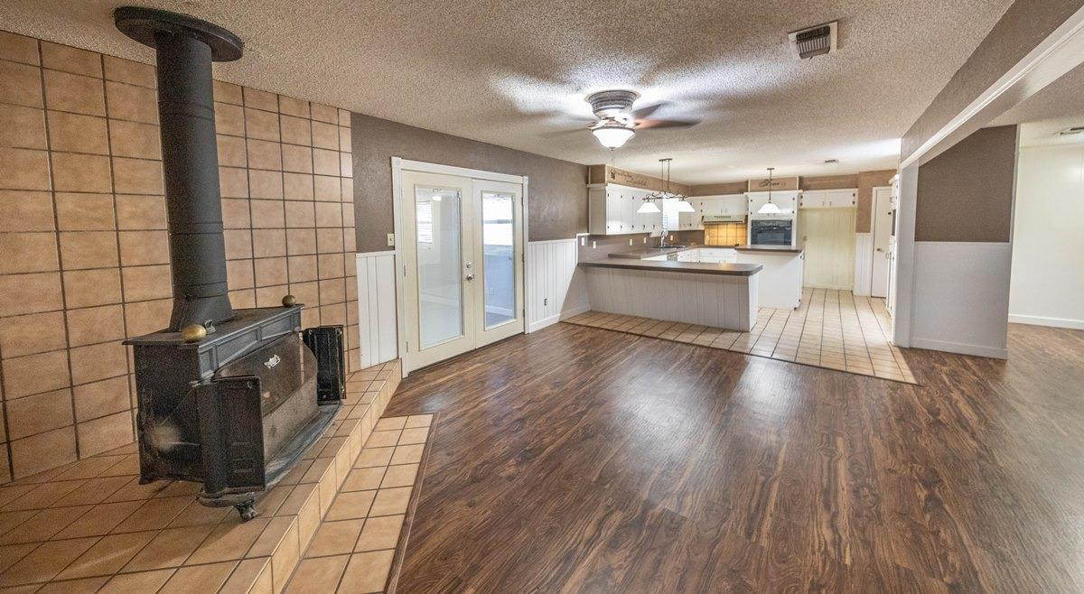 5415 8th Street Lubbock, TX 79416 - Photo 2 of 27 a view of a kitchen with furniture and wooden floor